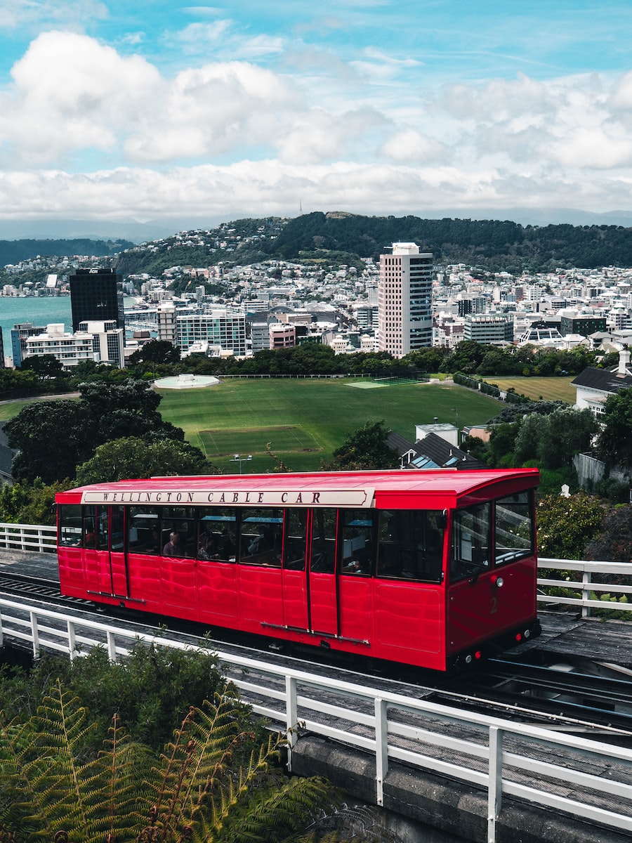 red and black train near buildings at daytime